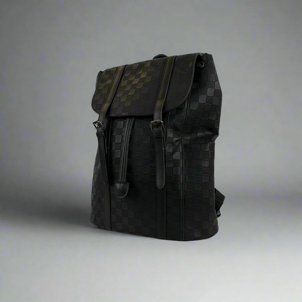 Black backpack on a white table with a white background