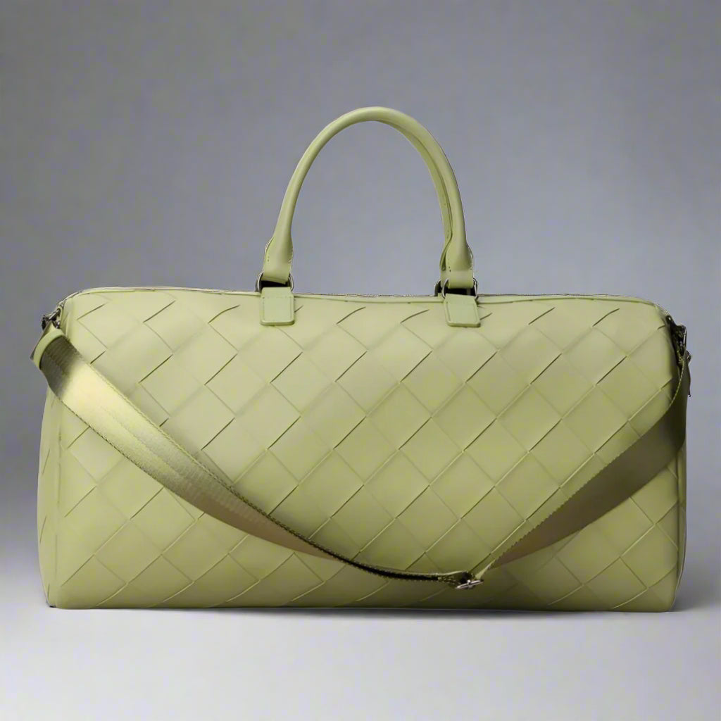Green woven handbag with a shoulder strap on a white background