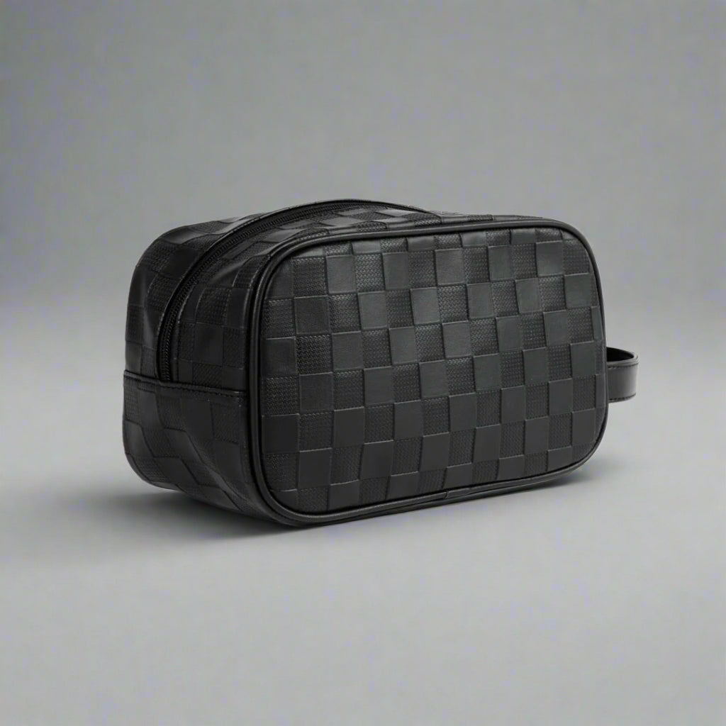 Black woven leather toiletry bag on a white background