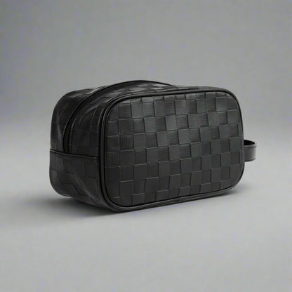 Black woven leather toiletry bag on a white background