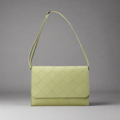 Green quilted handbag on a white background