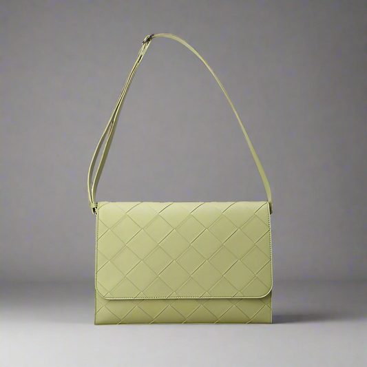 Green quilted handbag on a white background