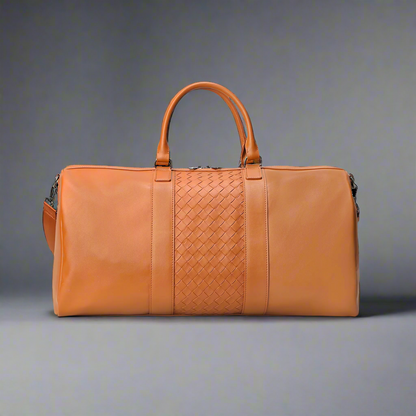 Brown leather duffel bag with woven pattern on a white background