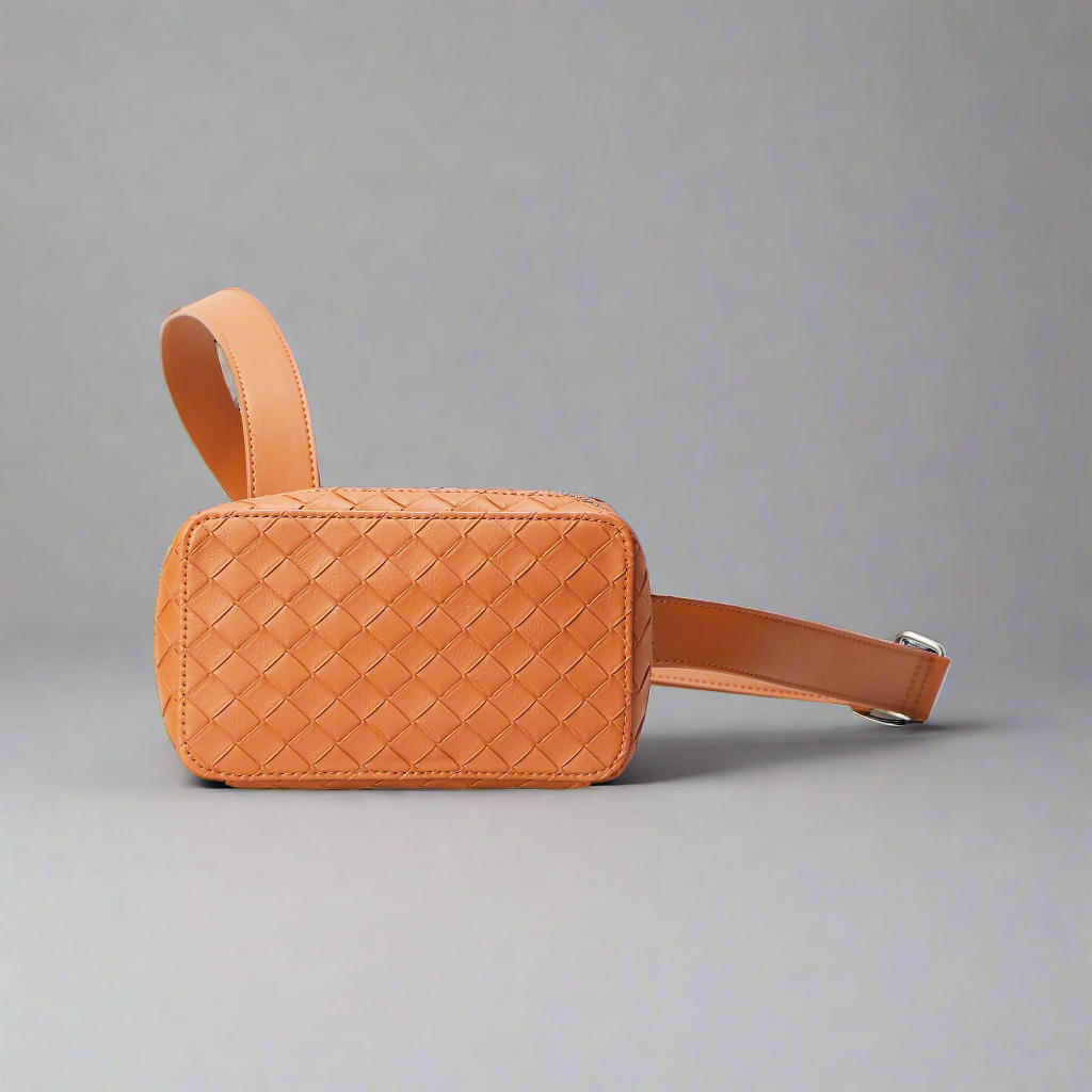 Brown woven leather bag with a strap on a white background