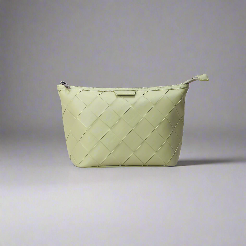 Light green woven handbag on a white background