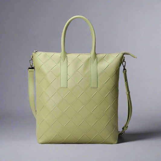 Light green woven handbag with a shoulder strap on a white background